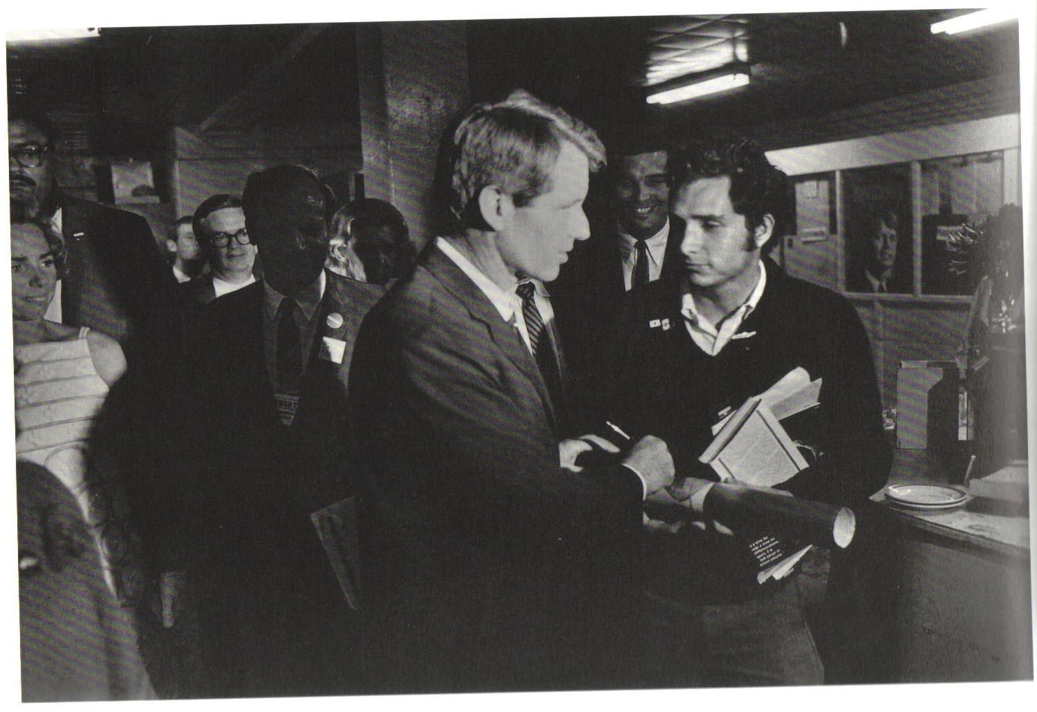 People's Exhibit 33; F3906:190; Trial; photo: RFK signing autograph for Michael Wayne